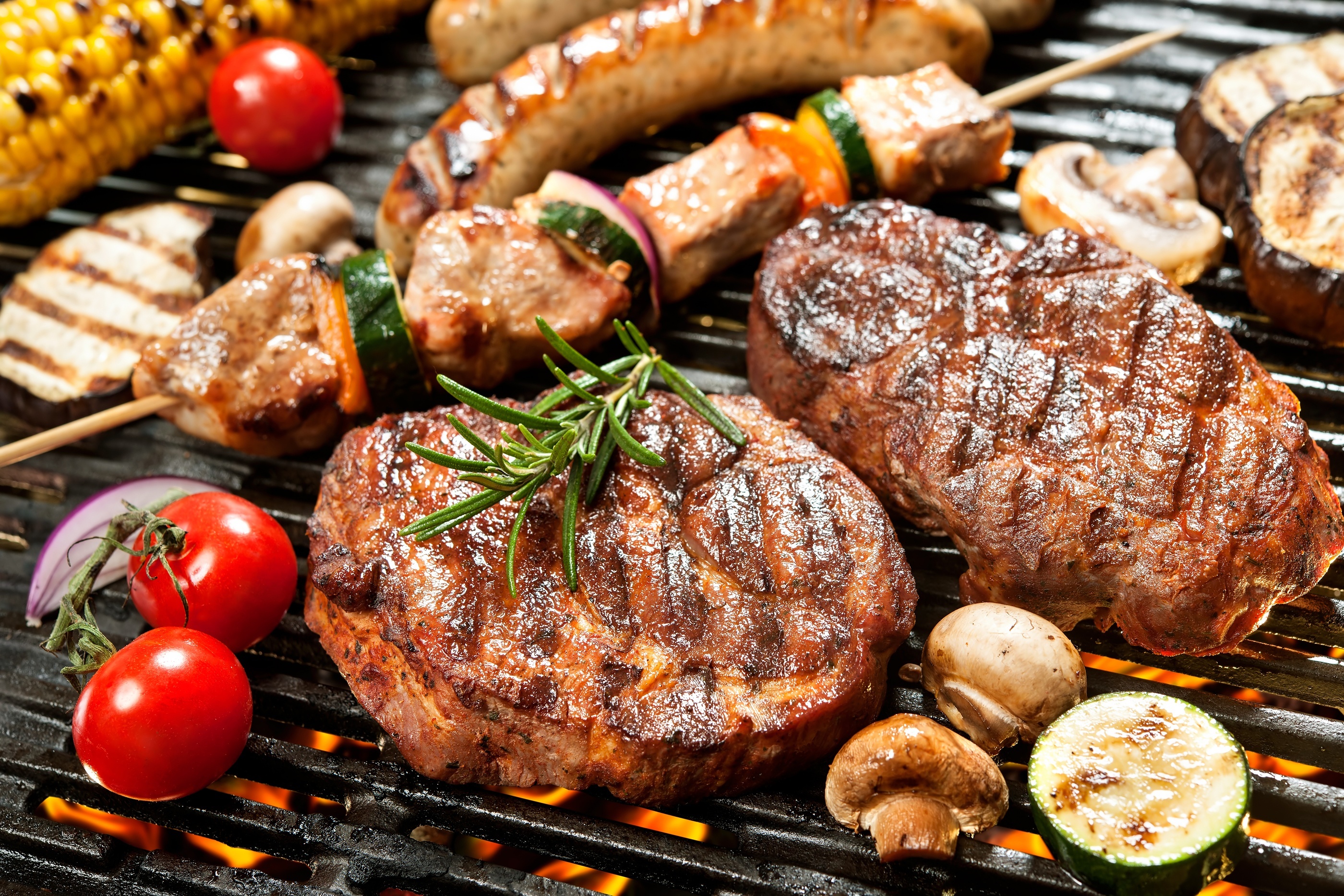 Assorted delicious grilled meat with vegetable over the coals on a barbecue