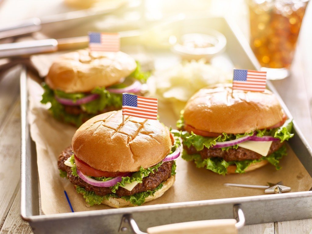 cheese burgers on tray with flags in 4th of july theme