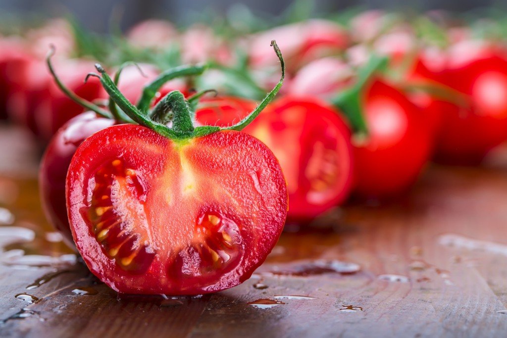 Fresh cherry tomatoes washed clean water. Cut fresh tomatoes.