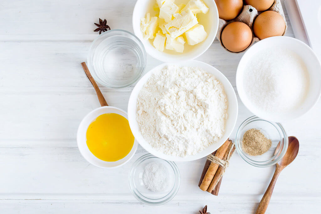 flour, sugar, eggs and butter on table