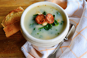 kale and potato bean soup with bread on the side