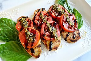 pesto tomato chicken on a plate