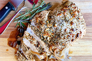 a roast turkey breast on a cutting board