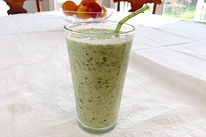 a creamy pineapple smoothie in a glass on the table