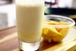 a mango smoothie in a glass