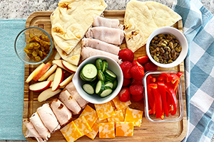 a meat, cheese, fruit and vegetable platter