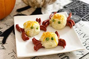 mashed potato balls and hot dog strips make to resemble a scary Halloween spider