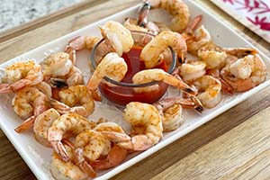 Shrimp cocktail on a serving tray with cocktail sauce