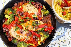 Mediterranean chicken dish in a cast iron skillet